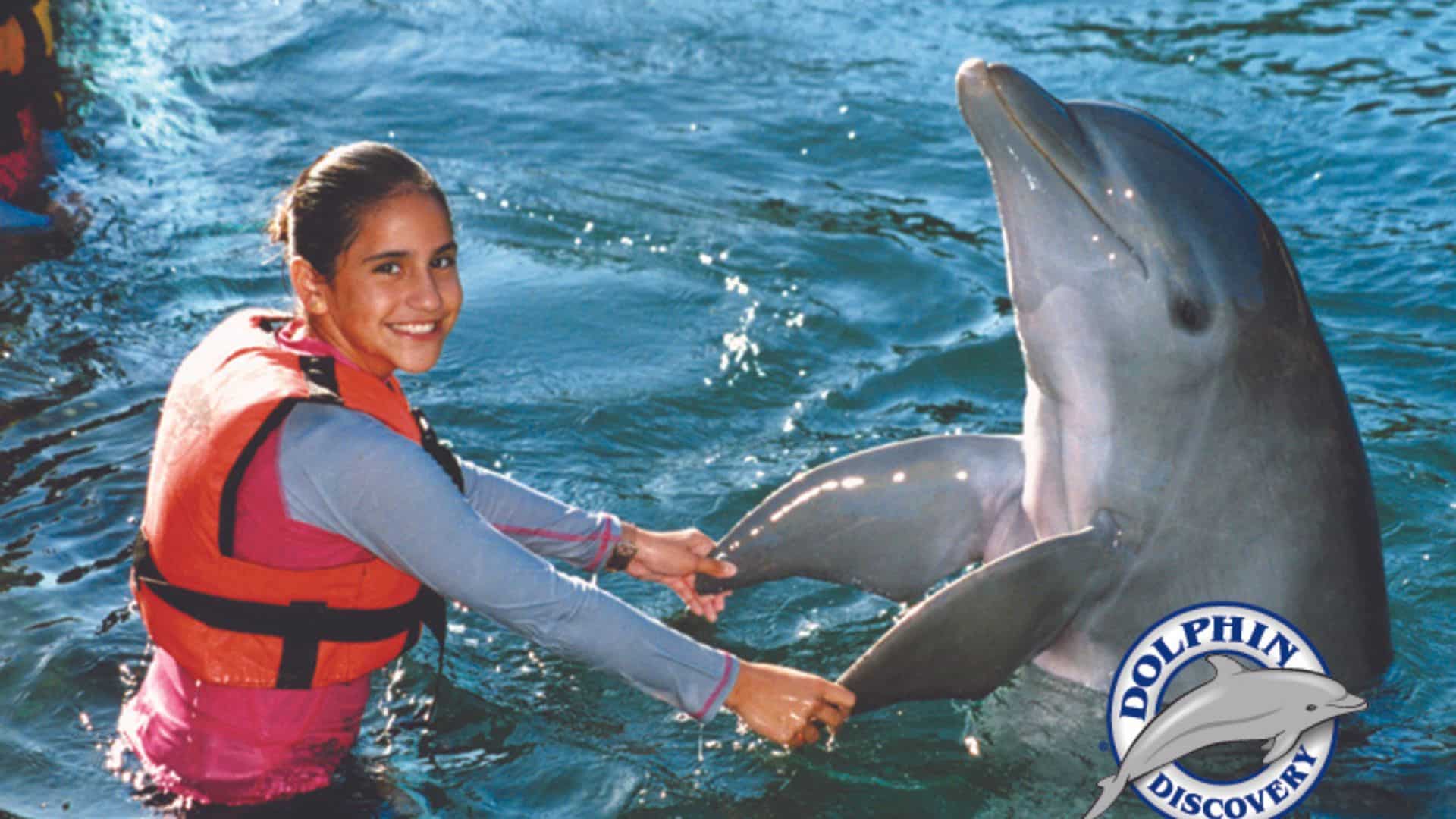 Pareja disfrutando del empuje de pie con delfines